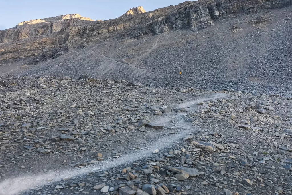 A distant hiker walking up a scree slope on EEOR