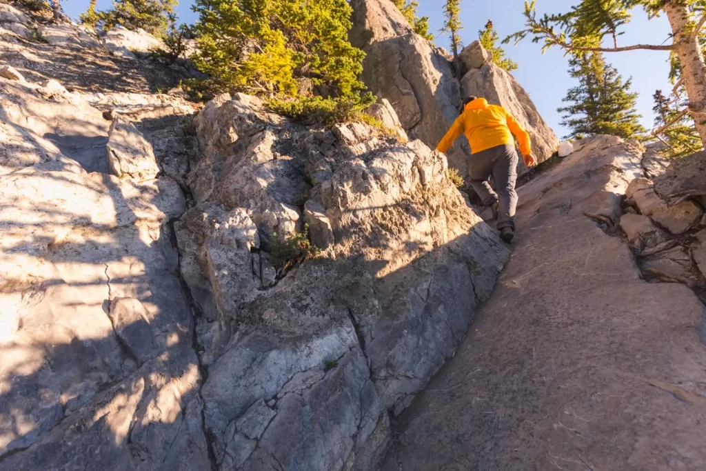 Scrambling up a slippery slab on the way up the EEOR hike