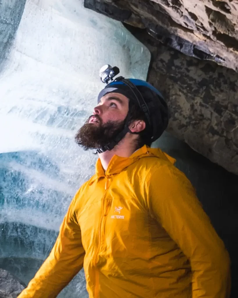 A portrait of J Quincy Harvey in a cave