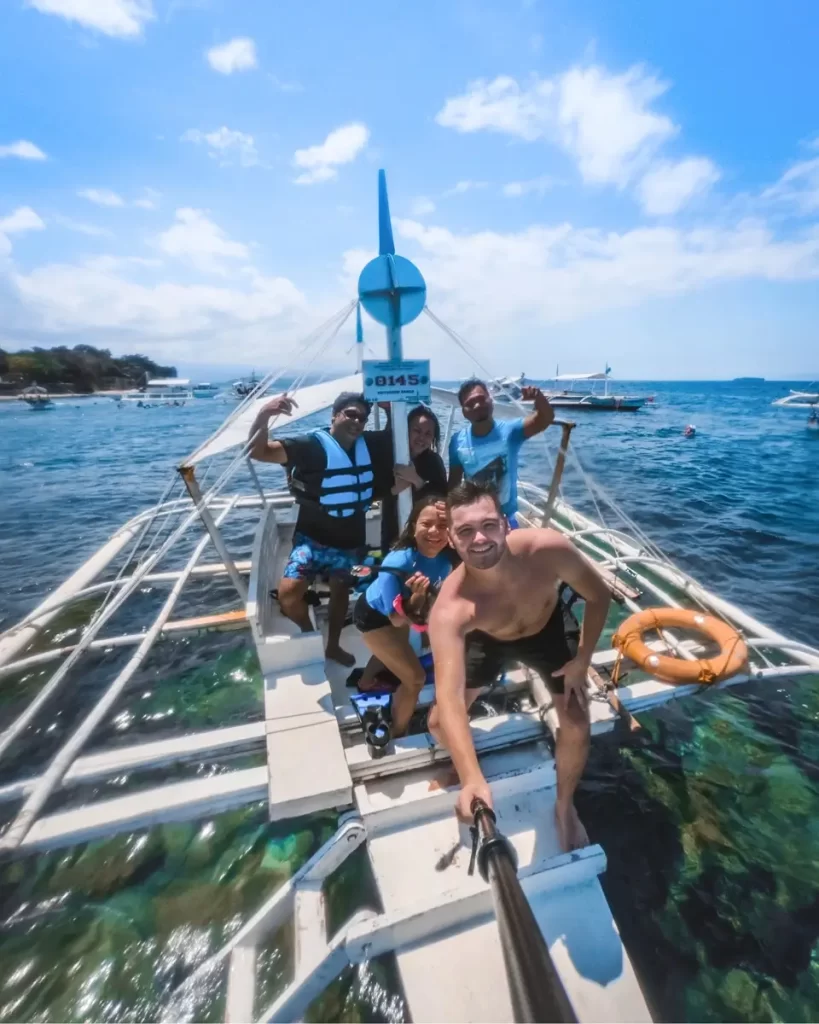 J Quincy Harvey on a boat in the Philippines