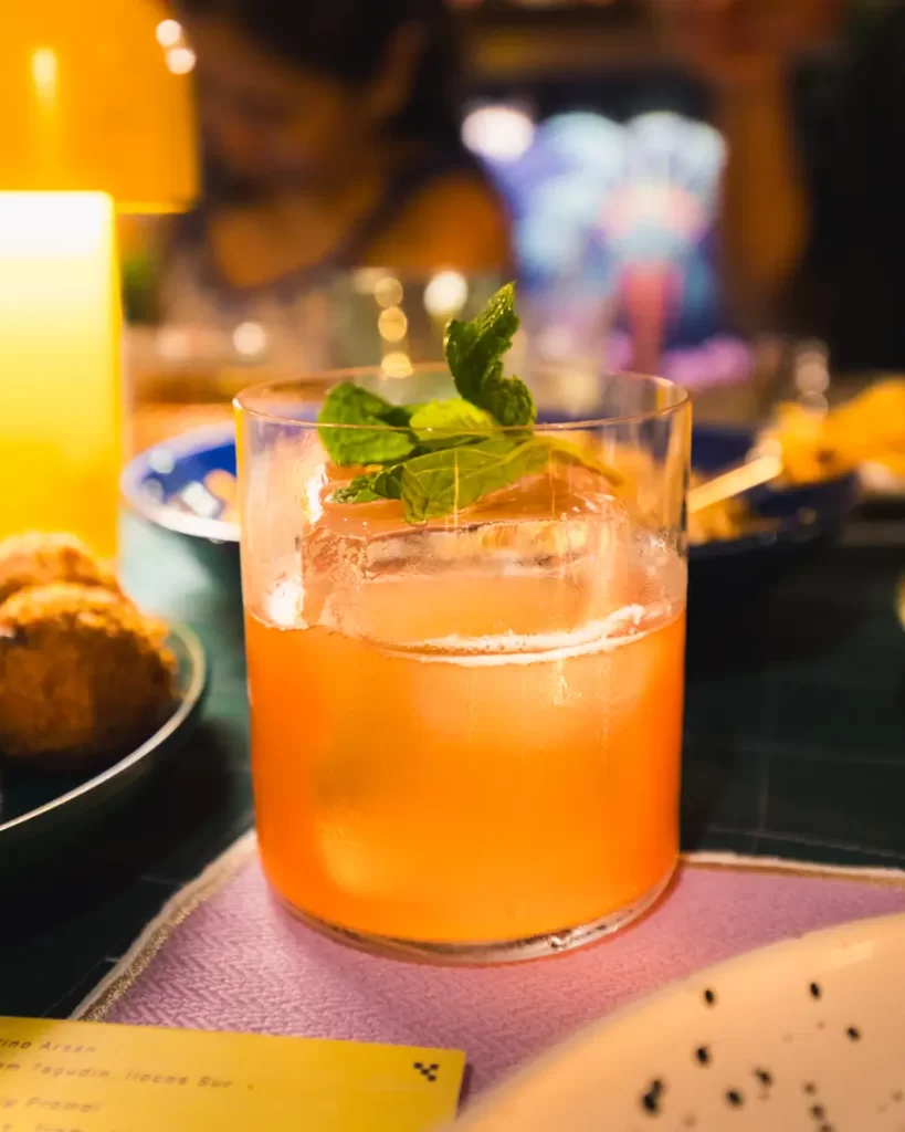 A museum exhibit, highlighted among Manila tourist spots, features large yellow information panels with text and photos in a dimly lit room of wooden beams, brick walls, tiled flooring, and historical artifacts in the background.